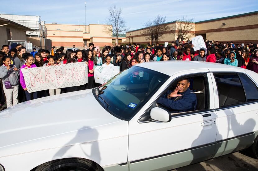 Coach Kevin MaBone is surprised with a car during a presentation by students and teachers on...