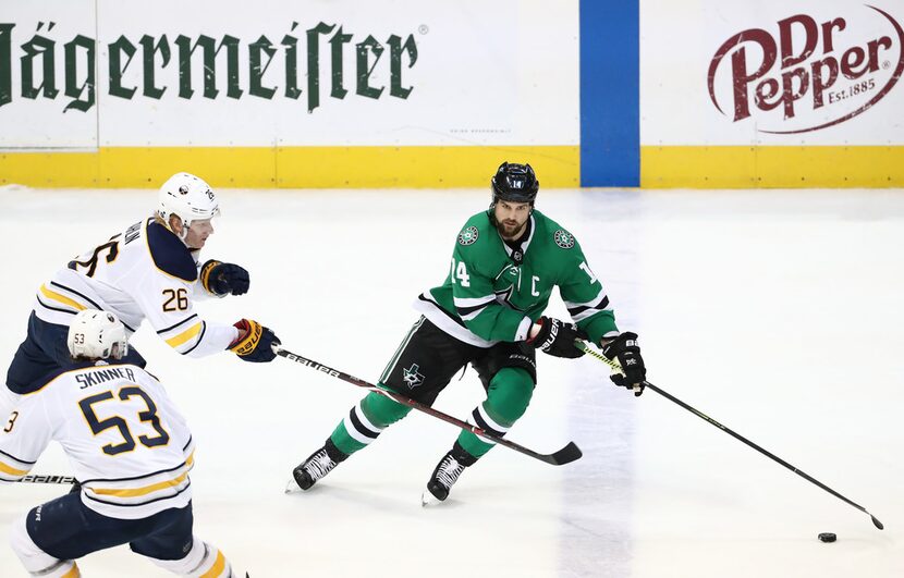 DALLAS, TEXAS - JANUARY 30:  Jamie Benn #14 of the Dallas Stars skates the puck against...