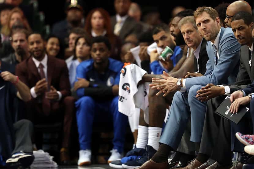 DALLAS, TX - OCTOBER 20:  Dirk Nowitzki #41 of the Dallas Mavericks sits on the bench during...