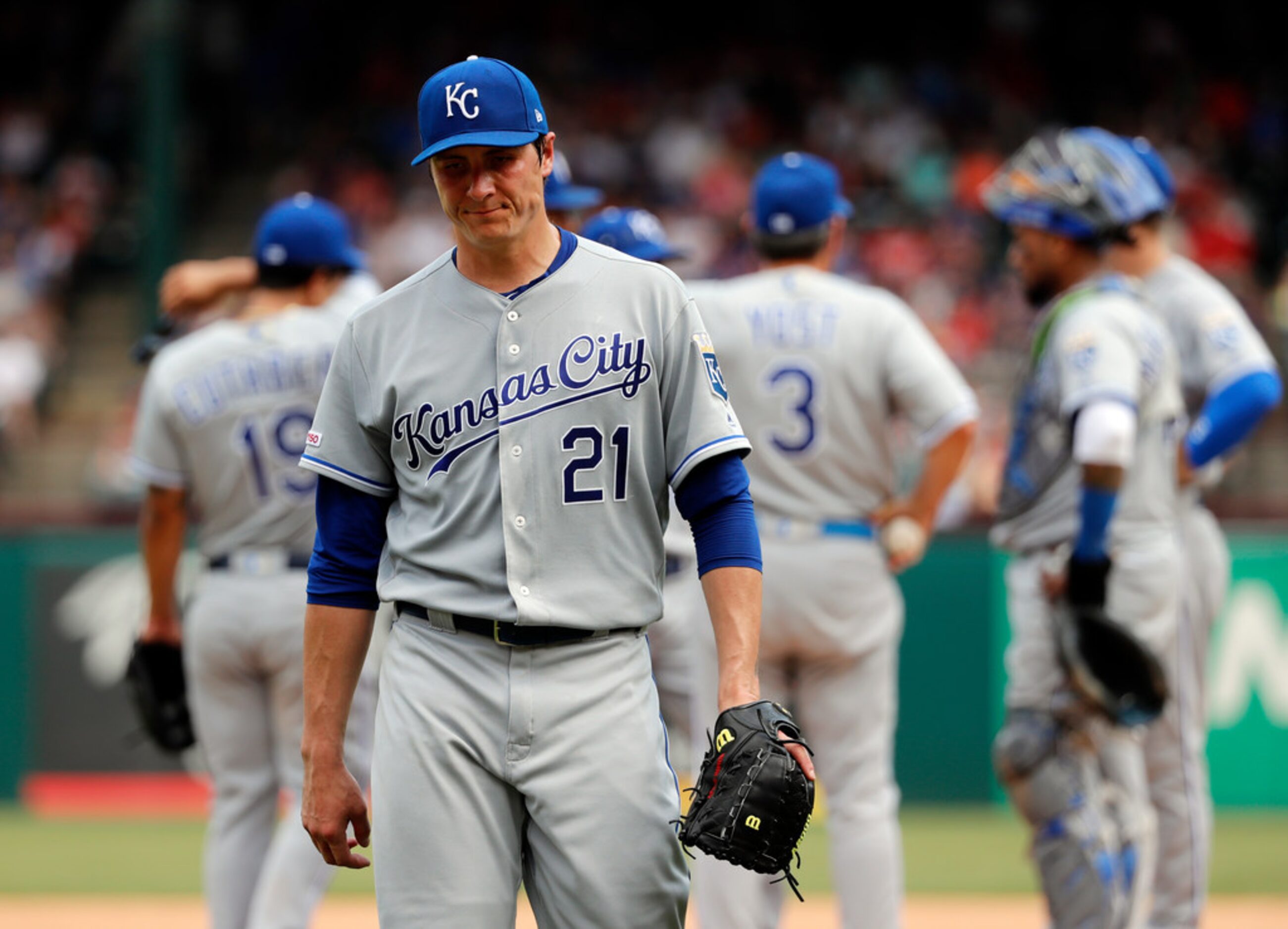 Kansas City Royals' Homer Bailey (21) walks to the dugout after turning the ball over to...