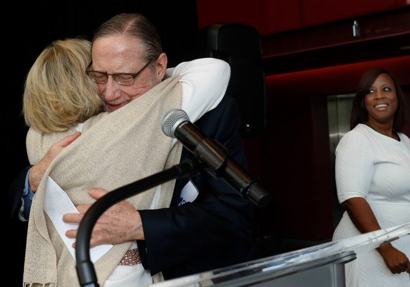 Camille Grimes embraces the Rev. Bruce Buchanan of The Stewpot of First Presbyterian Church...