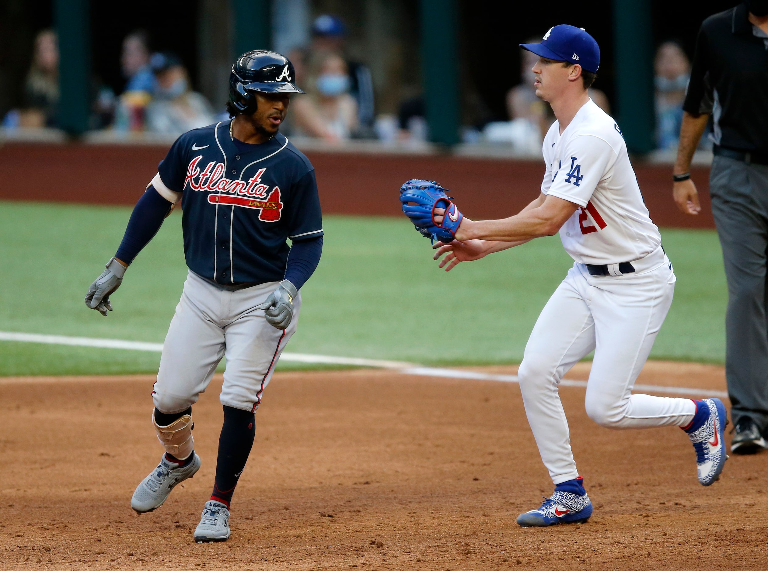 Los Angeles Dodgers starting pitcher Walker Buehler (21) tags Atlanta Braves batter Ozzie...