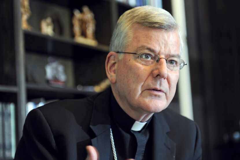  Archbishop John Nienstedt talks with a reporter at his office in St. Paul, Minn. in 2014....