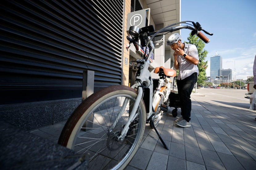 Hexel Colorado, who lives in downtown Dallas without a car, wears a helmet after his grocery...