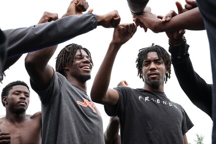 Pierre Goree  and his teammates huddle together at the end of practice on Tuesday, May 3,...