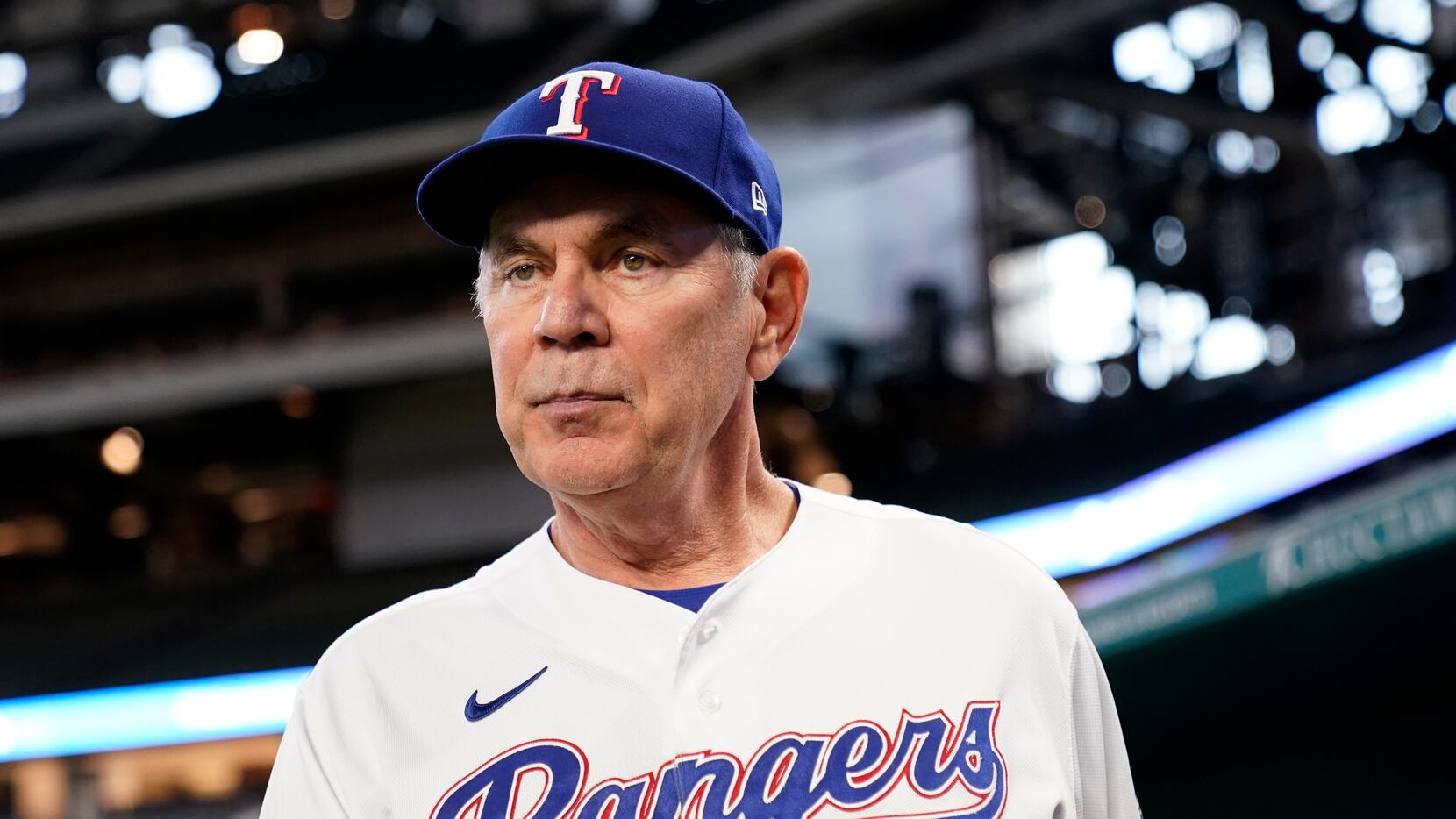 New Texas Rangers baseball team manager Bruce Bochy poses for photos in the dugout at Globe...