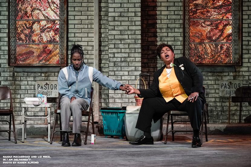 Effie (Naiqui Macabroad) and Sis (Liz Mikel) pray and sing in a church parking lot in a...