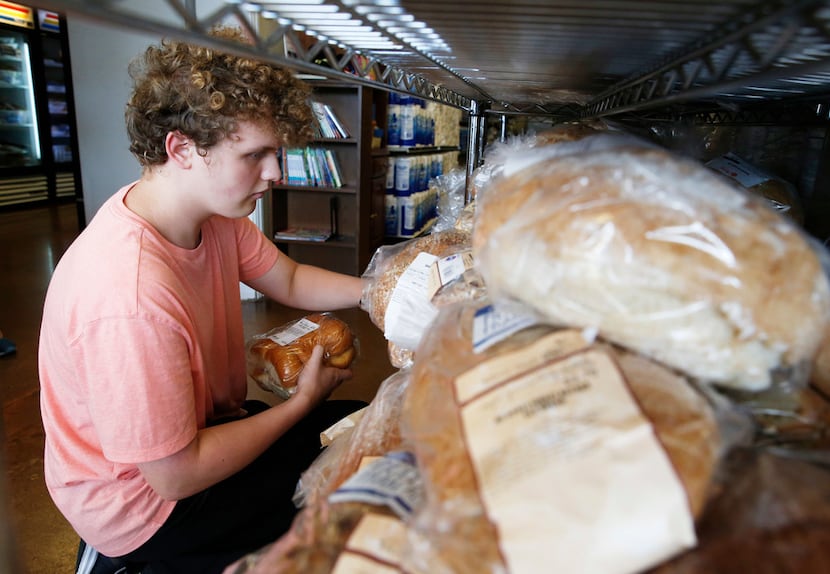 Volunteer Keegan Kasprowicz helped organize bread at Frisco Family Services Food Pantry on...