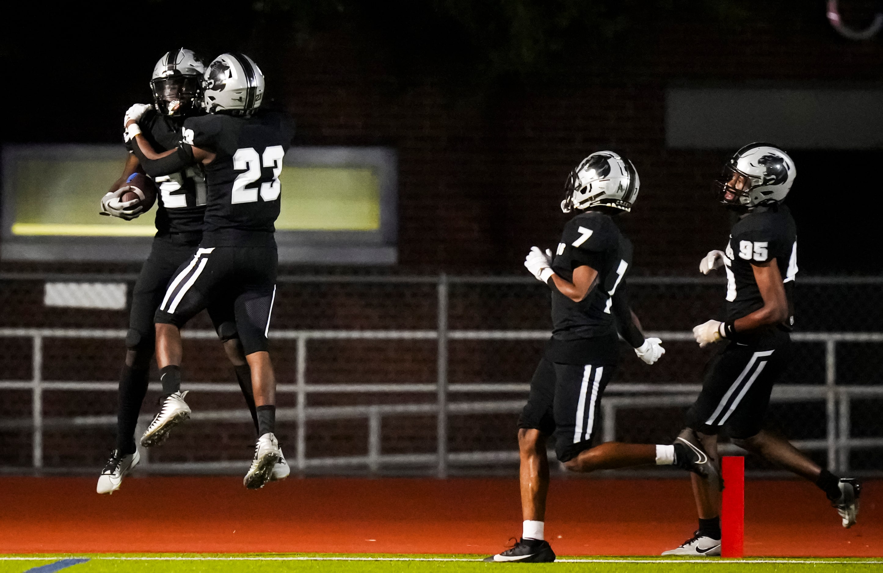 Panther Creek defensive back Donovan Webb (21) celebrates with Charles Bell (23) after...