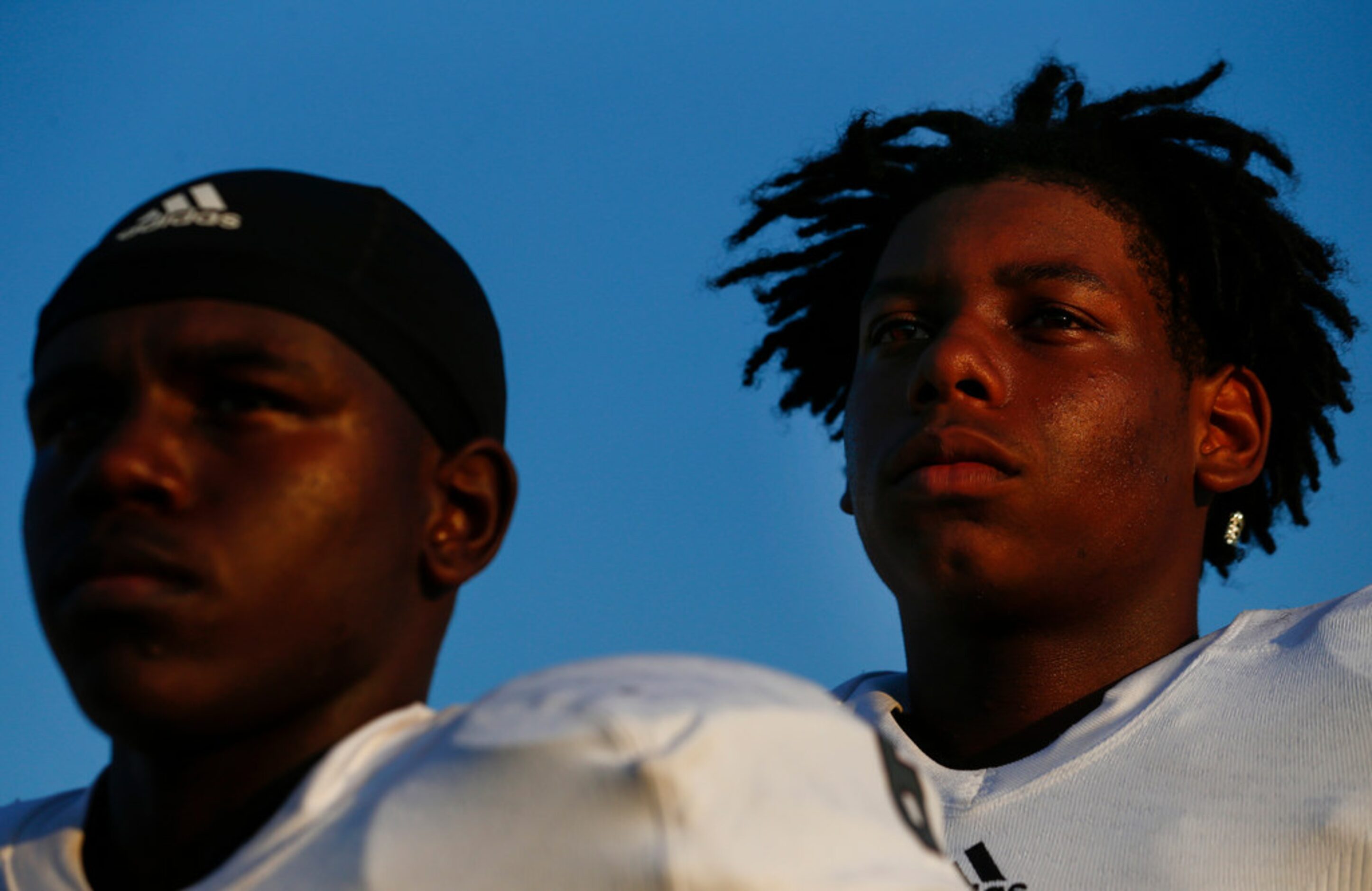 Ennis wide receiver Karon Smith, left, and tight end Michael Collins stand for the national...