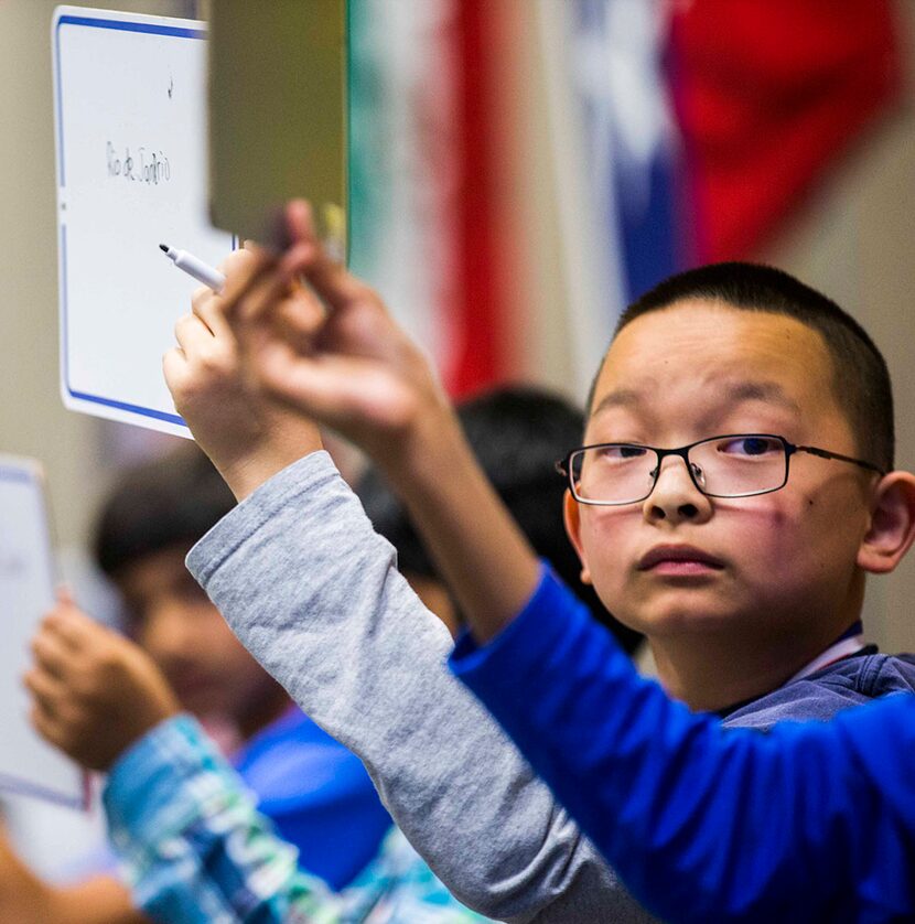  Thomas Lu, sixth grader from McCulloch Intermediate School in Dallas, compares his answer...