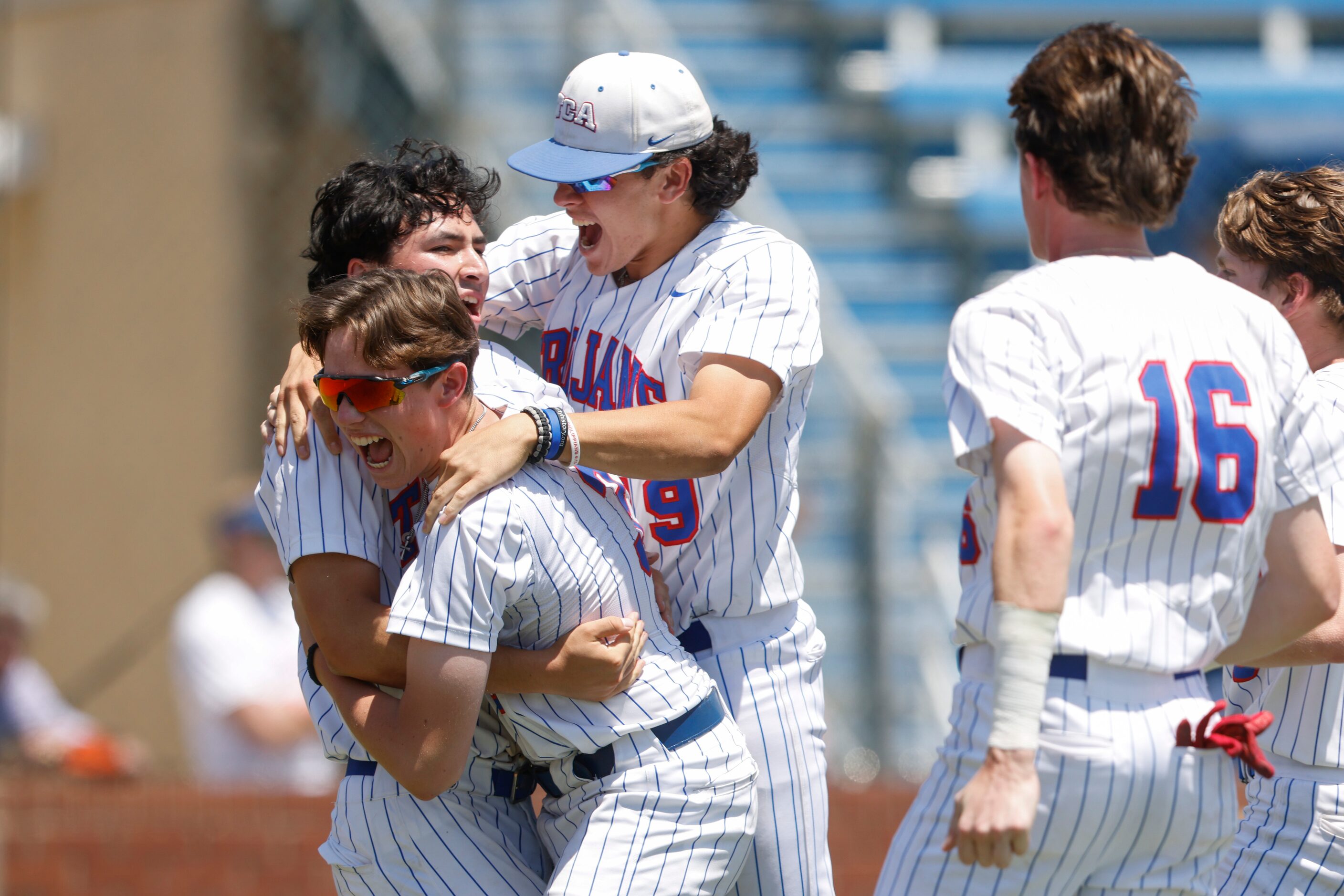 Trinity Christian players run to hug Joshua Liu (9) after his game winning run off of...