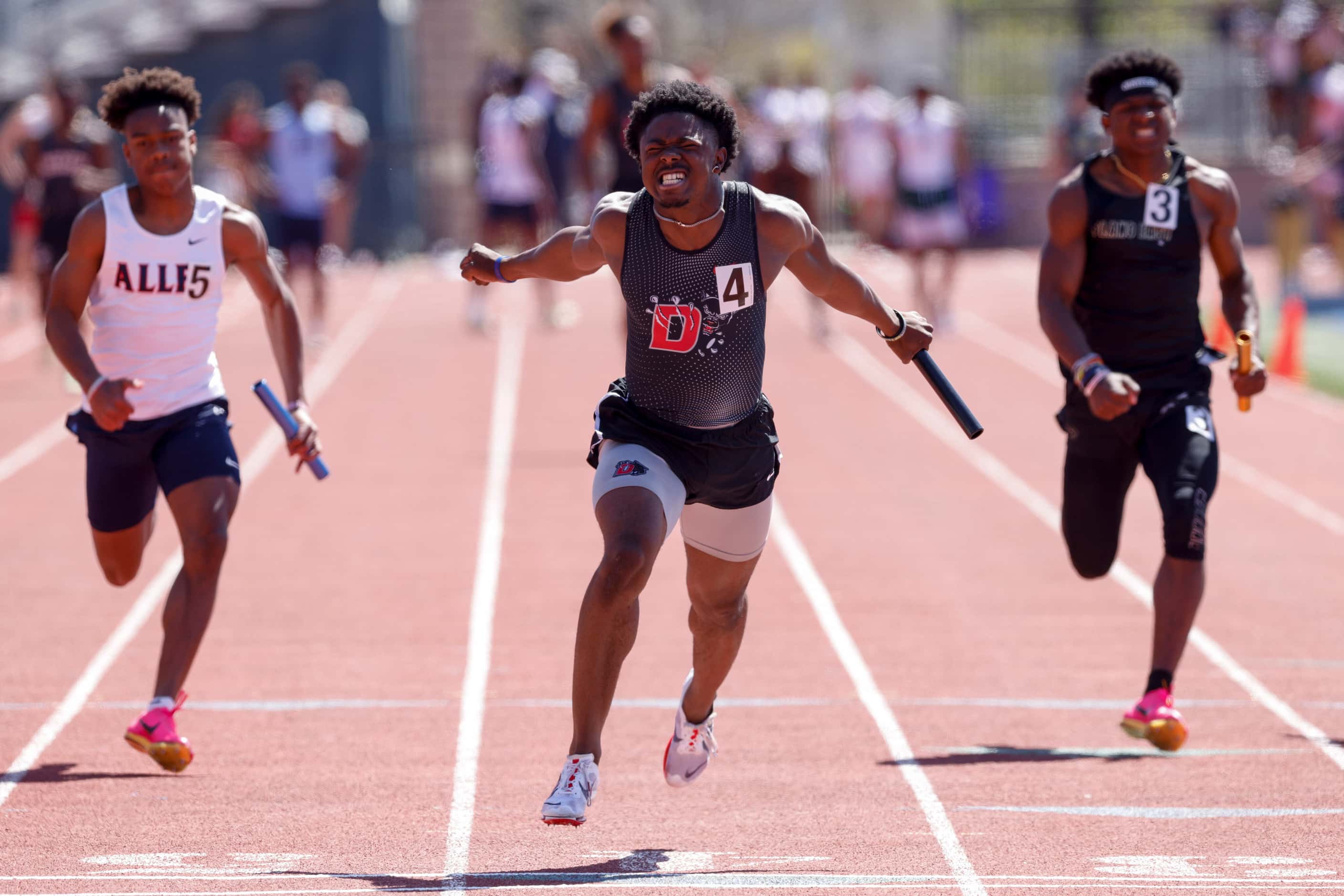 Duncanville’s Jaylen Washington dives across the line to win the boys 4x100 relay during the...