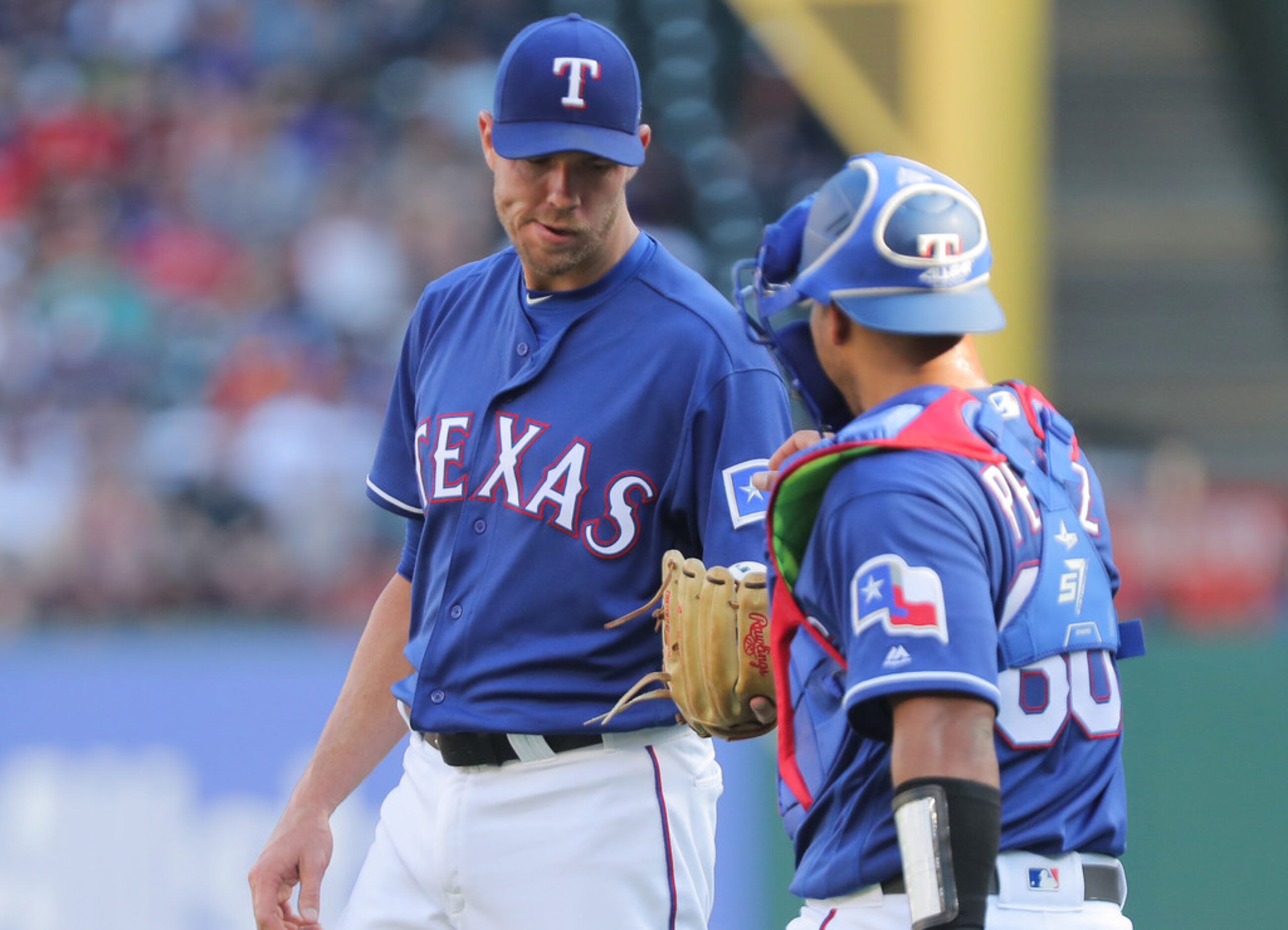 Texas Rangers starting pitcher Doug Fister (38) gets a visit from catcher Carlos Perez (60)...