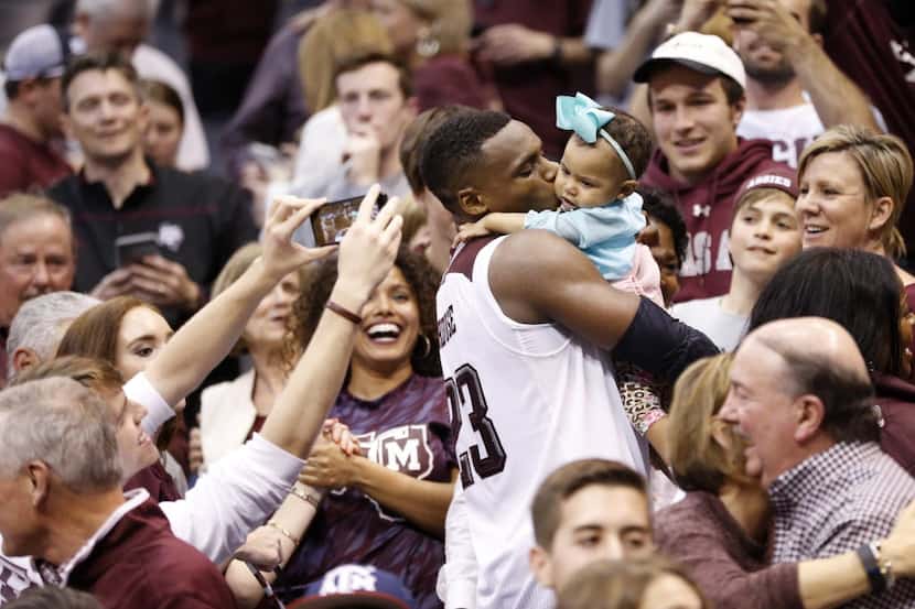 Texas A&M Aggies guard Danuel House (23) kisses his daughter Ava Kennedy House after...