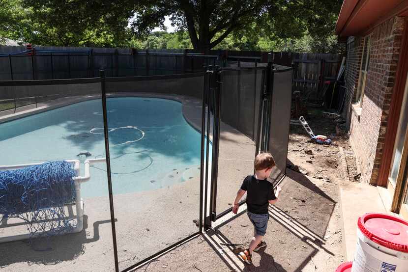 Fred Dixon, 2, walked by the pool in the backyard of this home on Friday, May 27, 2022, in...