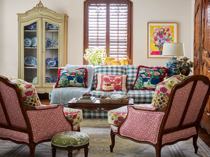 Bright, cheerful sitting room with couch and chairs upholstered in bold patterns.