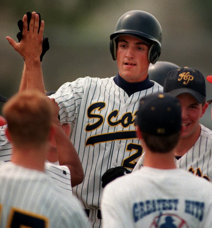 May 21, 1998 -- Highland Park's Chris Young is congratulated  at home plate after hitting a...