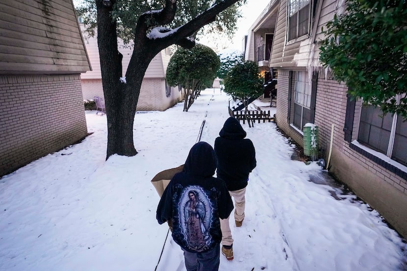 Jose Guadalupe, 18, (right) and his brother
Alexander Guadalupe,14, carry cases of drinking...