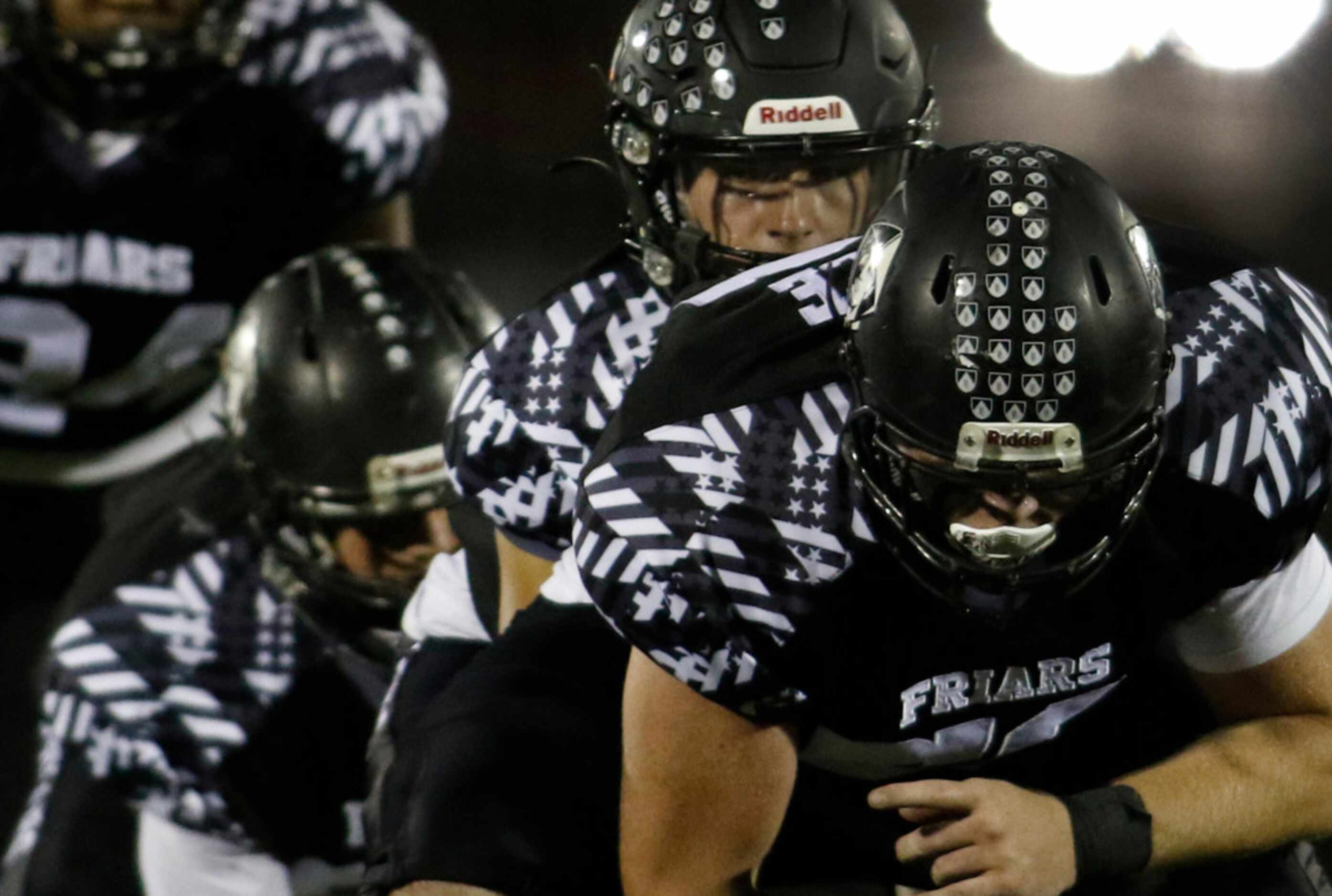 Bishop Lynch quarterback Michael Light (1) peeks from under center during a first quarter...