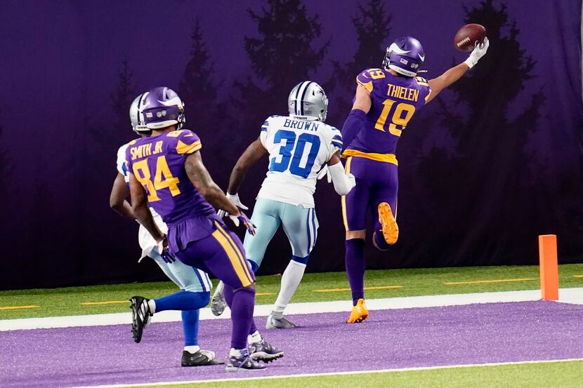 Minnesota Vikings wide receiver Adam Thielen (19) catches a 2-yard touchdown pass ahead of...