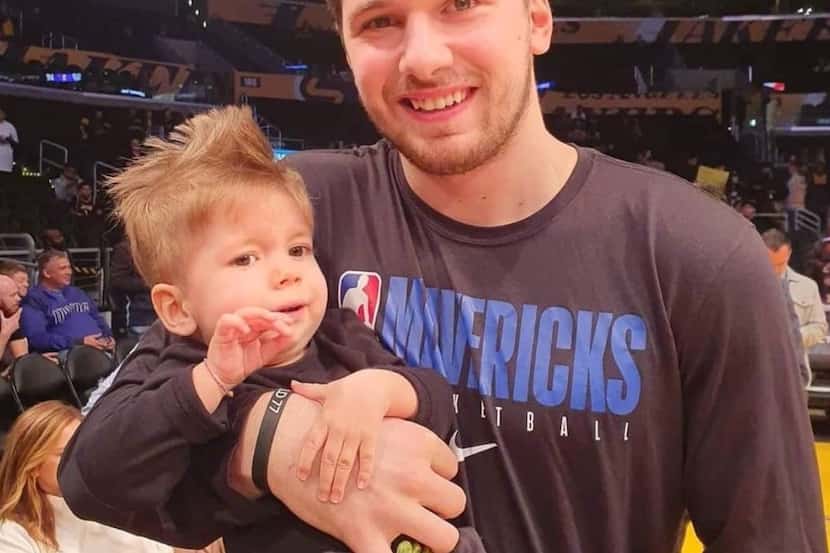 Luka Doncic holds Kris Zudich, the 22-month-old Slovenian boy with a rare genetic disease...