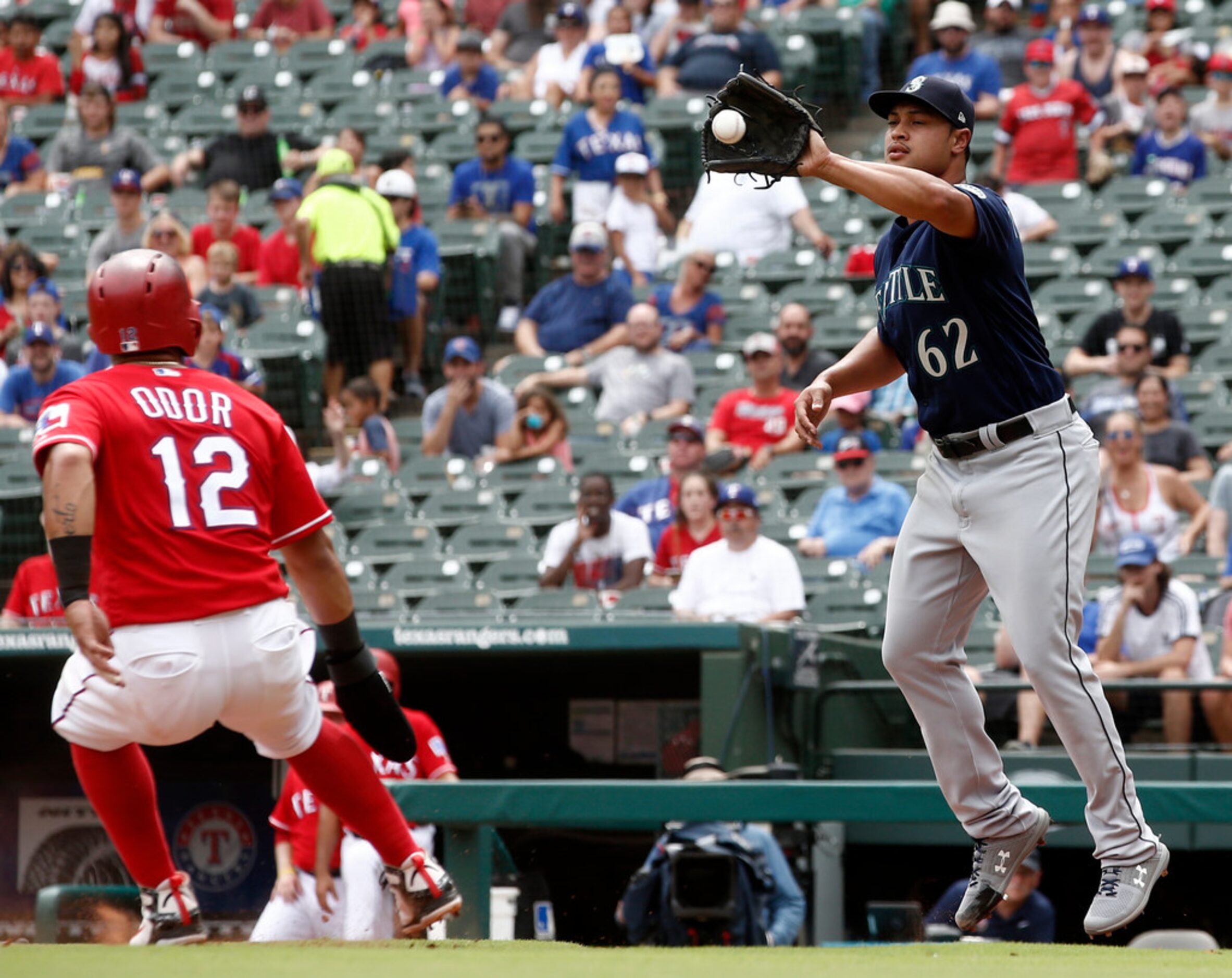 Seattle Mariners pitcher Sam Tuivailala (62) handles the ball as Texas Rangers Rougned Odor...