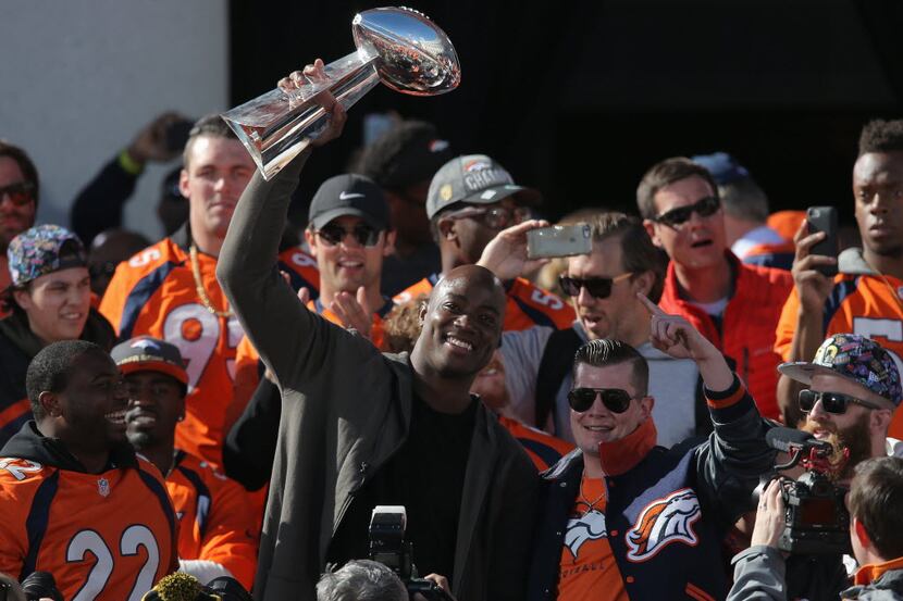 DENVER, CO - FEBRUARY 09:  DeMarcus Ware (C) of the Denver Broncos hoists the Lombardi...