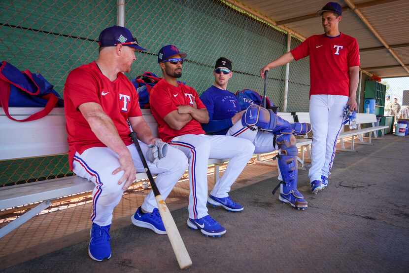 From left, Texas Rangers outfielder Kole Calhoun, infielder Marcus Semien, catcher Mitch...