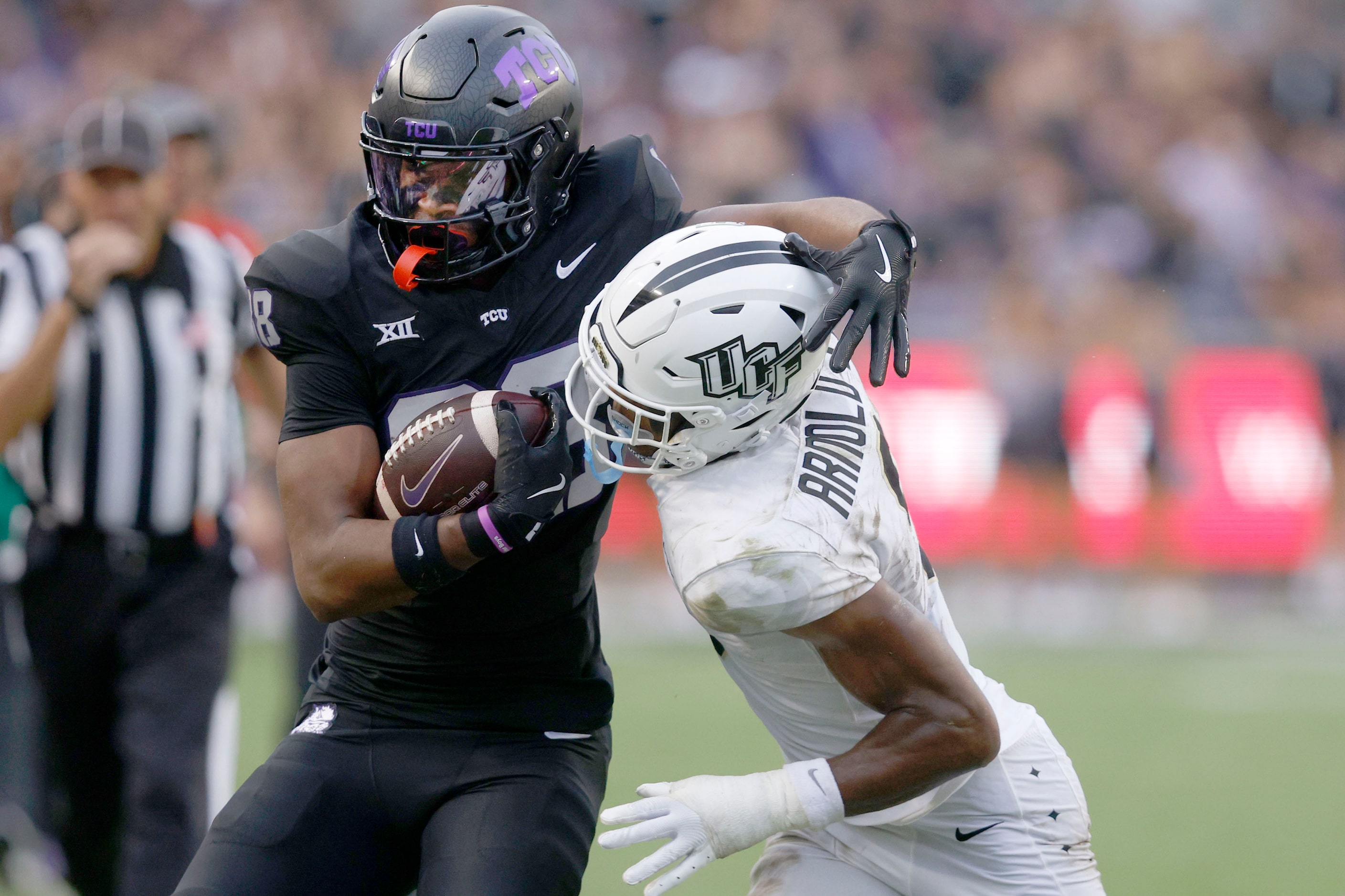 TCU wide receiver Eric McAlister (88) is tackled by UCF defensive back Sheldon Arnold...