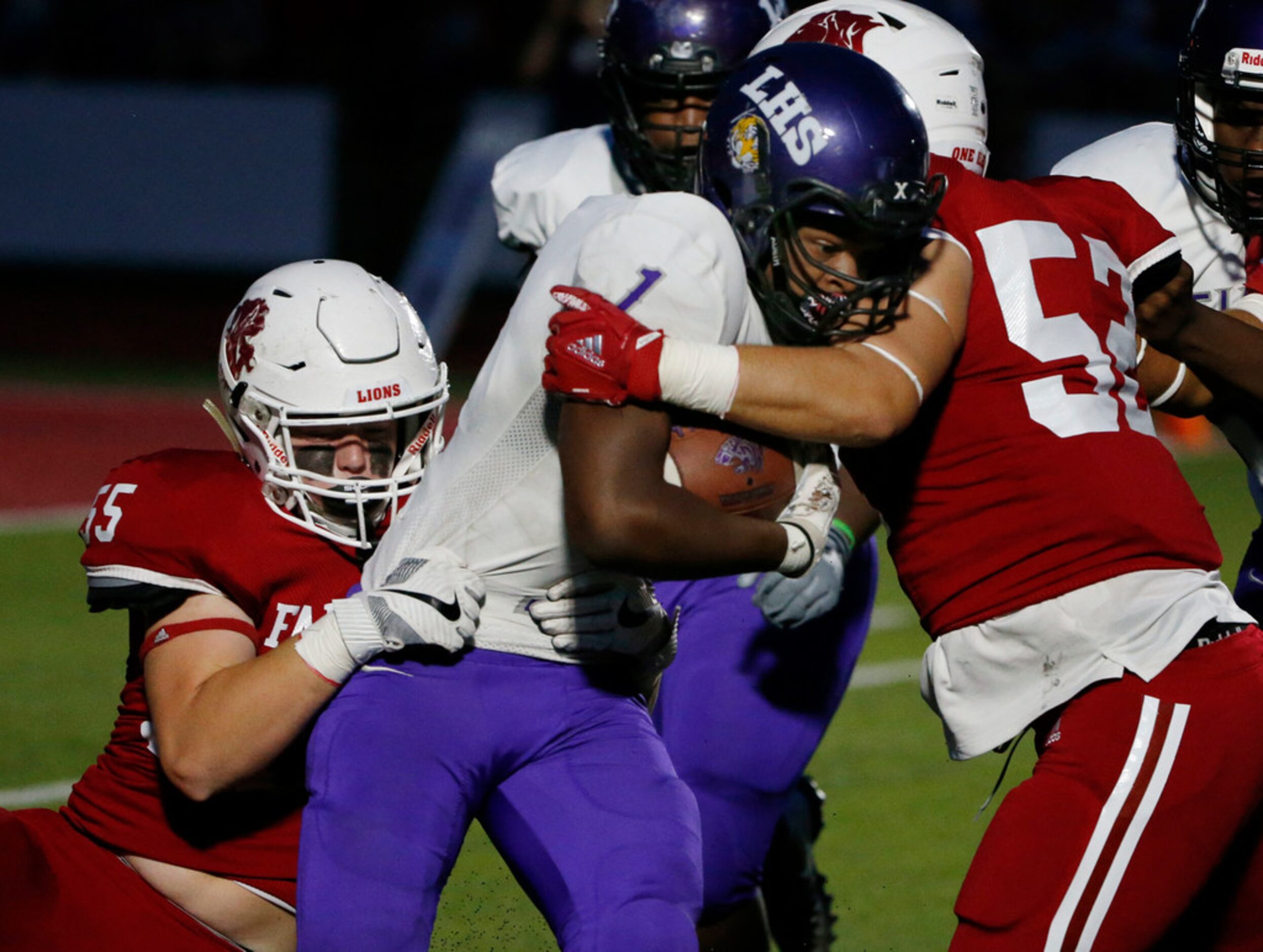 Grapevine Faith Christian players Carter Boyd (55) and Preston Parkhill (52) tackle...