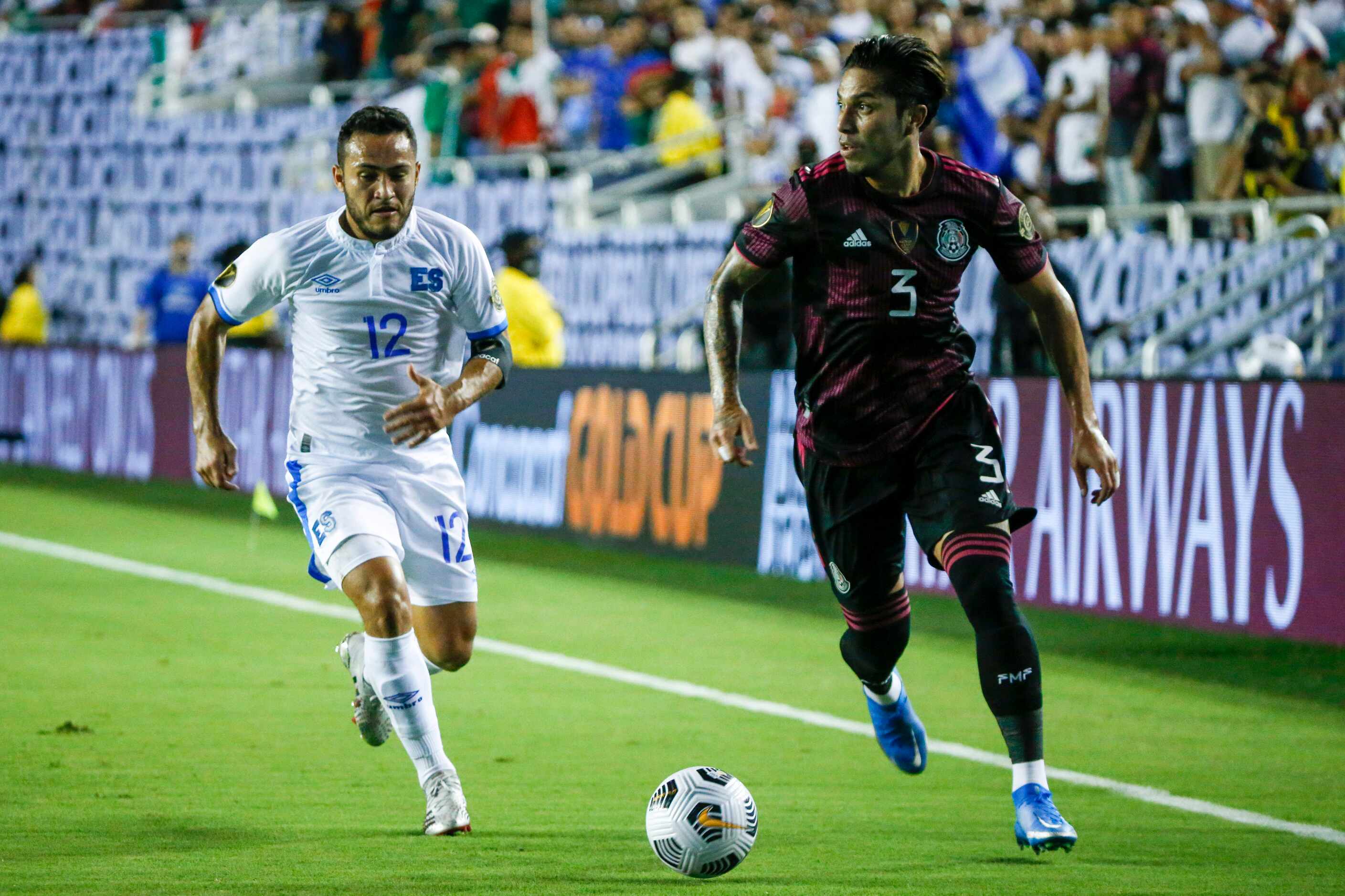 Mexico defender Carlos Salcedo (3) dribbles the ball ahead of El Salvador midfielder Marvin...
