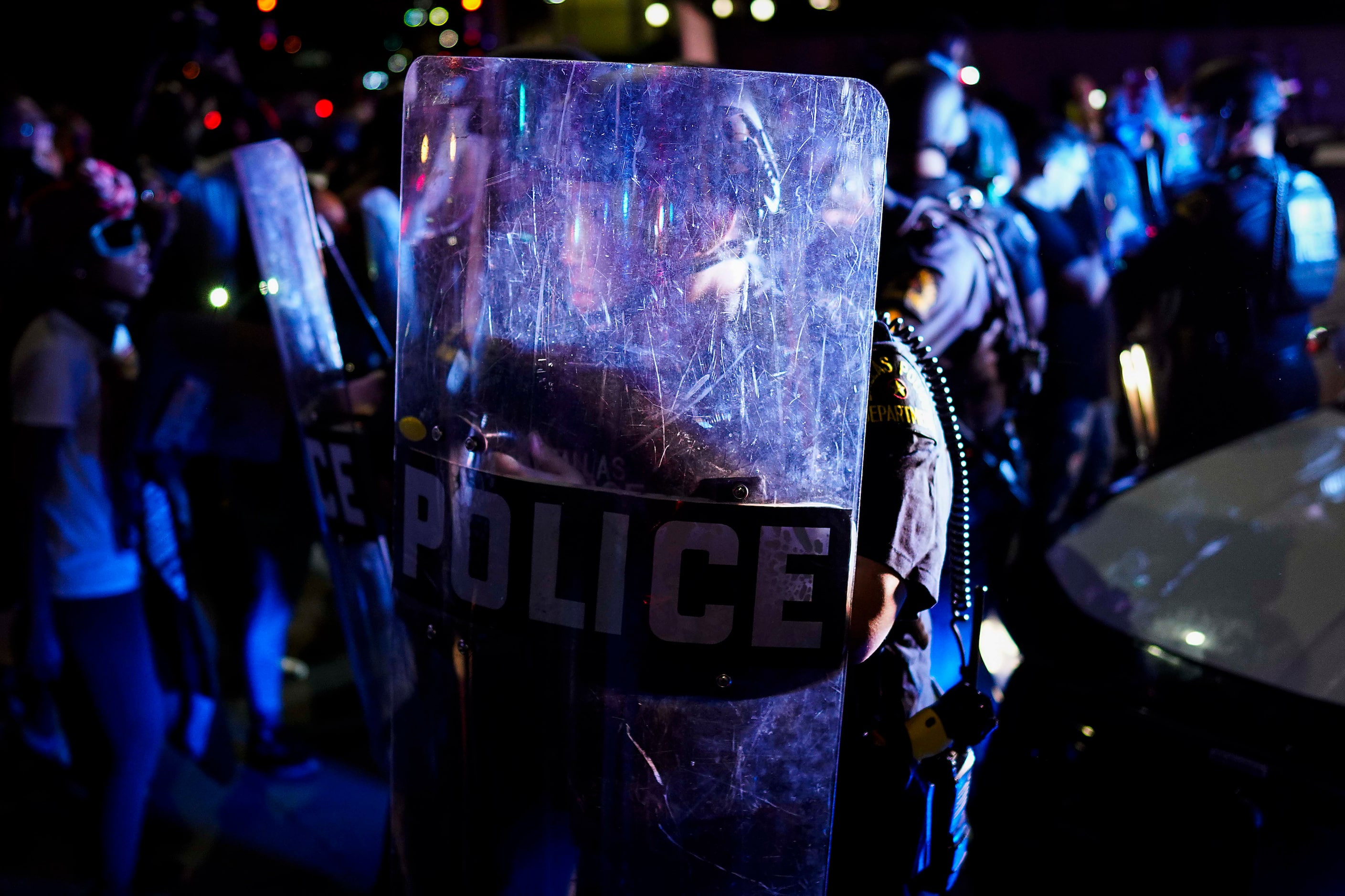 Dallas police clash with protesters at the corner of of Griffin and Young Streets as they...