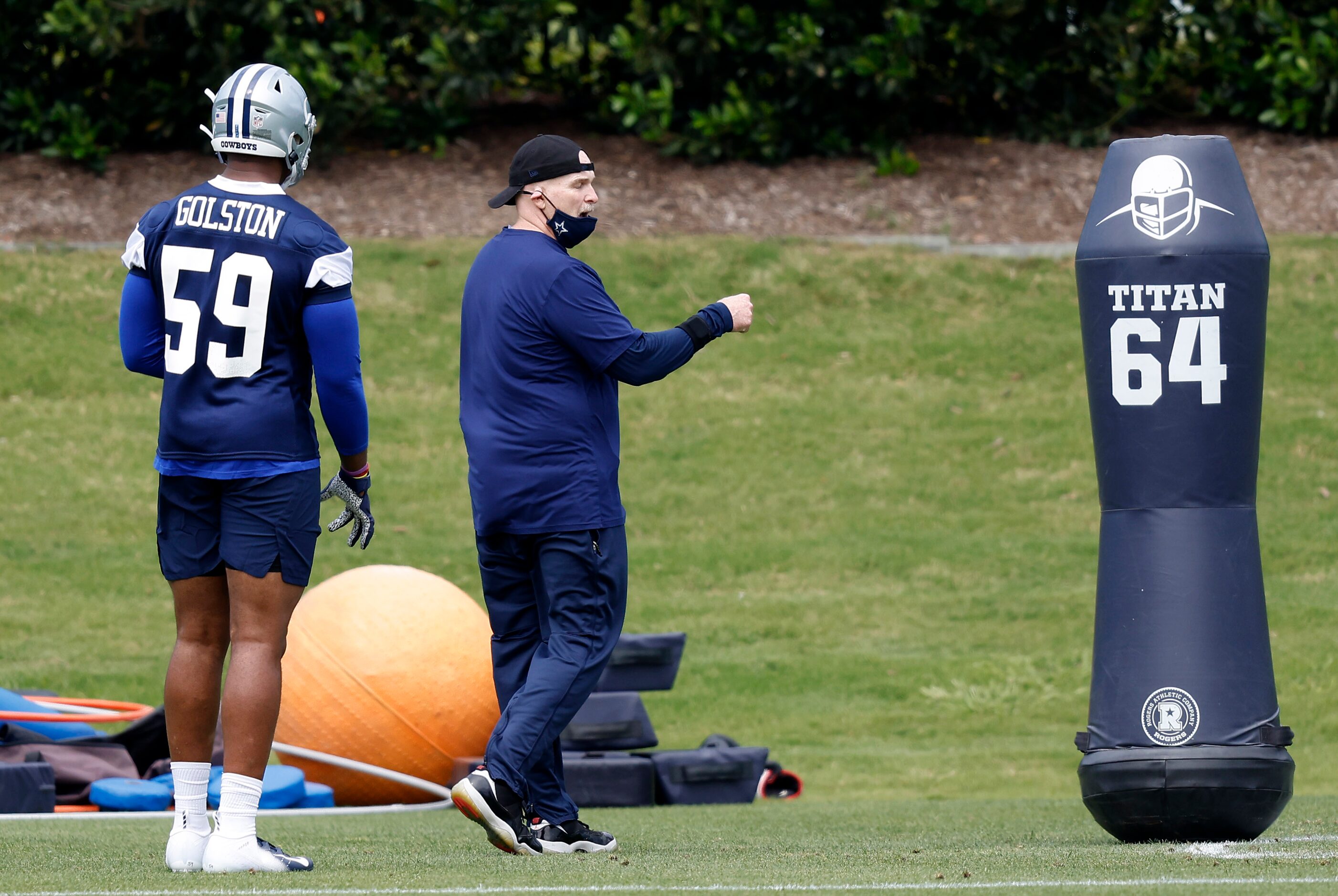 Dallas Cowboys defensive coordinator Dan Quinn gives instruction to rookie defensive end...