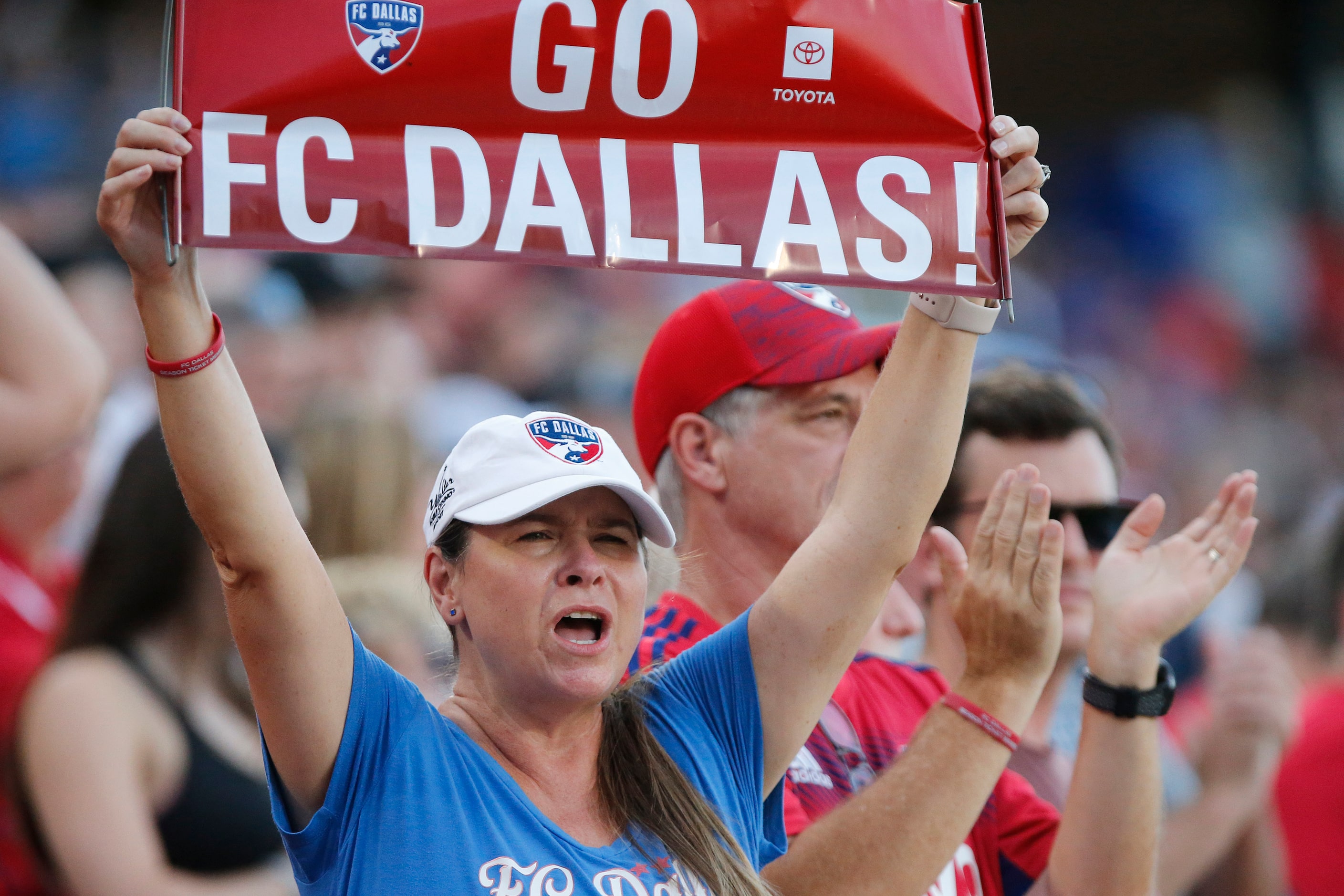 FC Dallas fan Shannah Miner of Prosper, welcomes the team to the pitch before the game as FC...