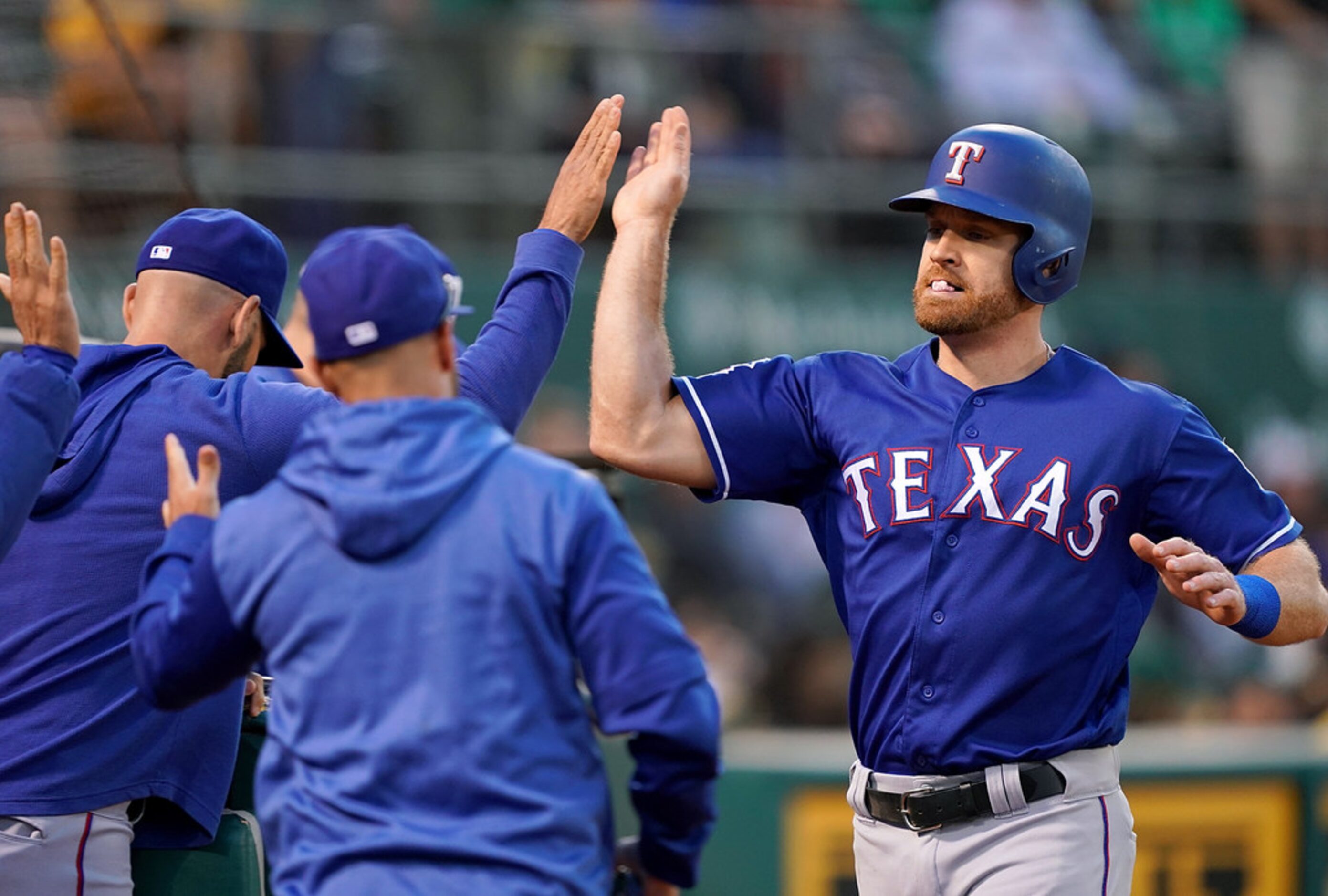 OAKLAND, CA - JULY 25:  Logan Forsythe #41 of the Texas Rangers is congratulated by...