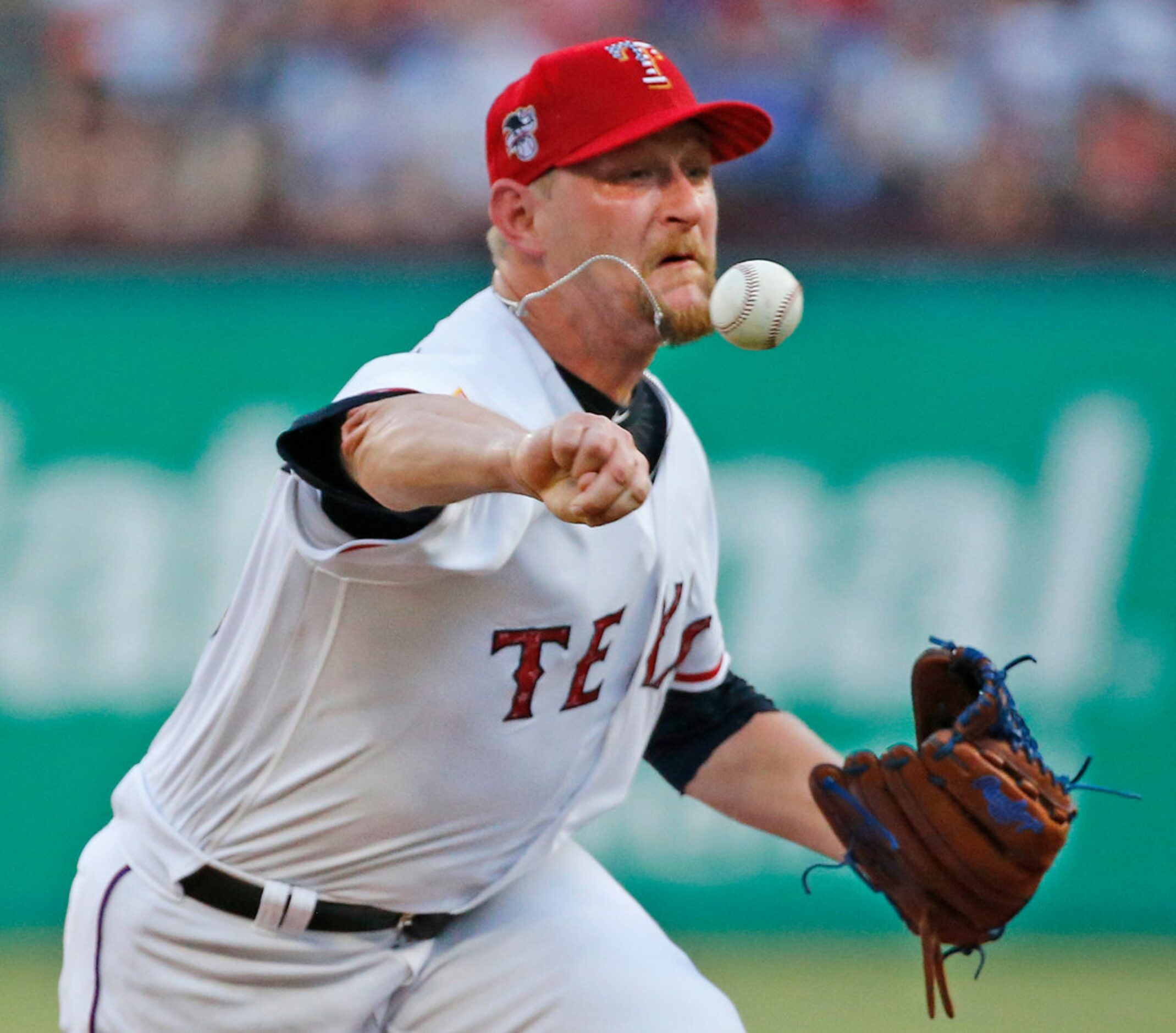 Texas Rangers starting pitcher Austin Bibens-Dirkx (56) throws a first inning pitch during...