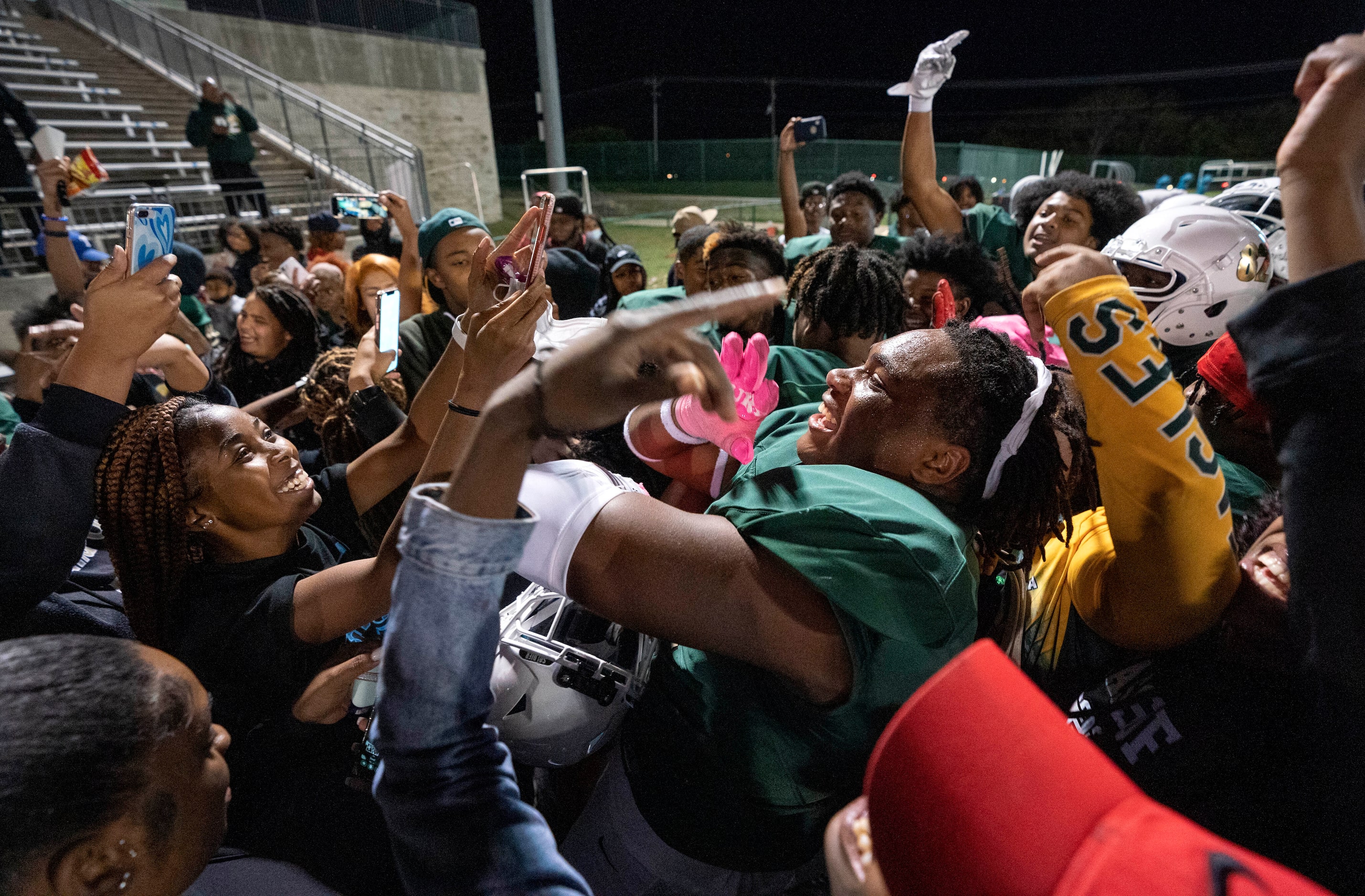 DeSoto senior defensive lineman Keshawn Williams (91), center, celebrates with fans after a...