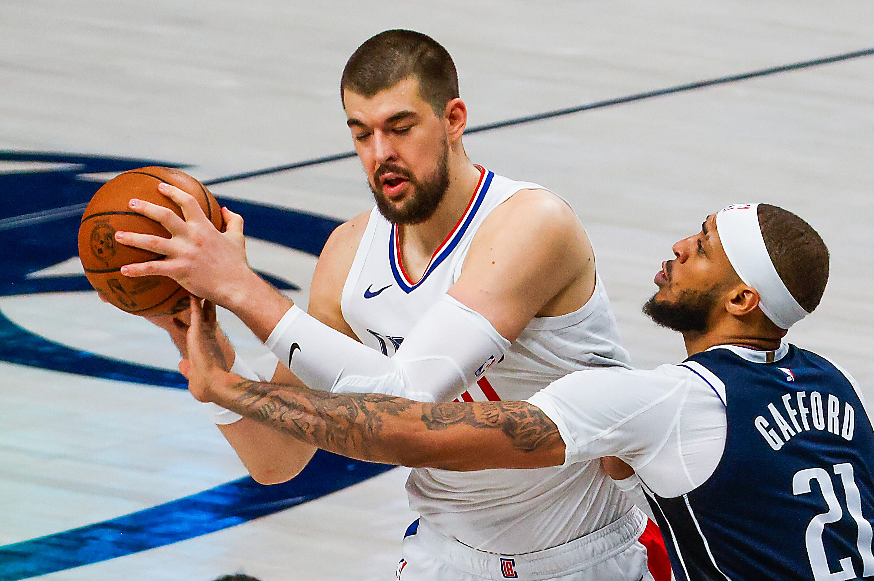 LA Clippers center Ivica Zubac  takes away the ball from Dallas Mavericks center Daniel...