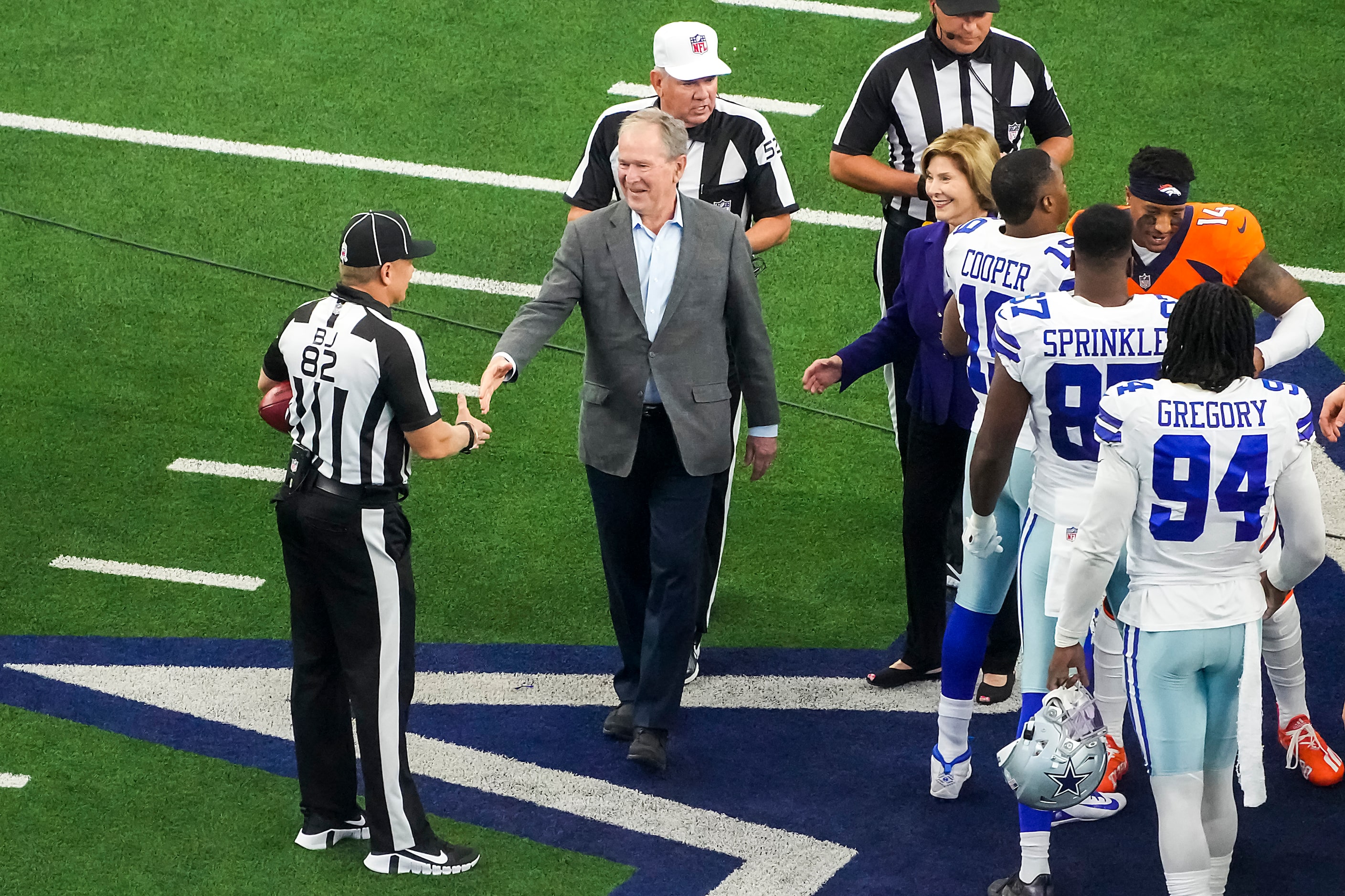 Former President George W. Bush shakes hands with official Jimmy Russell (82) after...