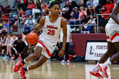 Lake Highlands junior guard Tre Johnson looks for room against the Arlington Bowie defense...