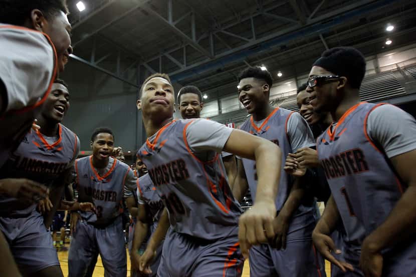 Lancaster guard Darius Anderson (00) leads the team in a dance after beating Kimball in the...