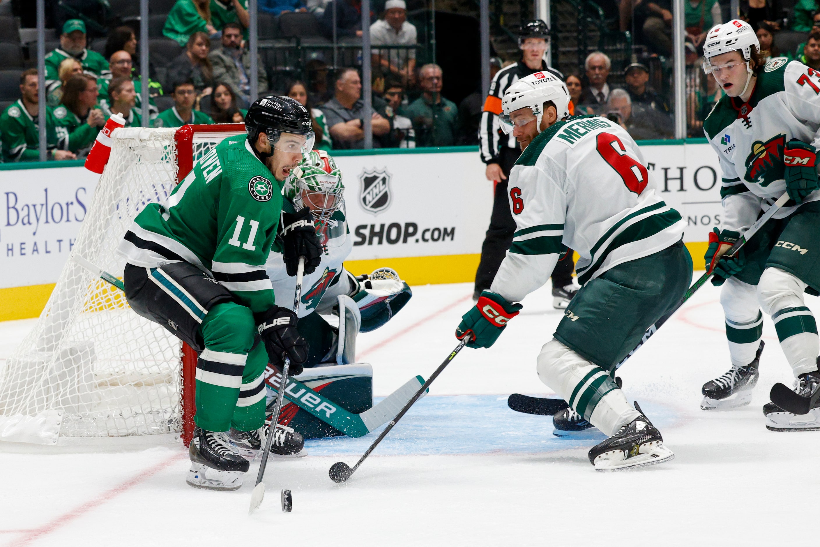 Dallas Stars center Logan Stankoven (11) looks to. Pass the puck near Minnesota Wild...