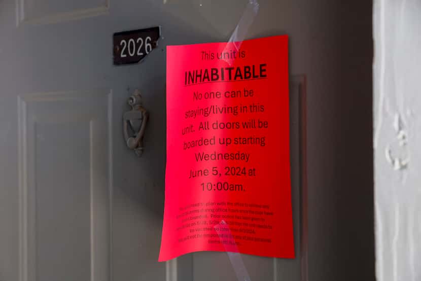 A sign marking an apartment as inhabitable hangs on the door of an apartment at the Meadows...