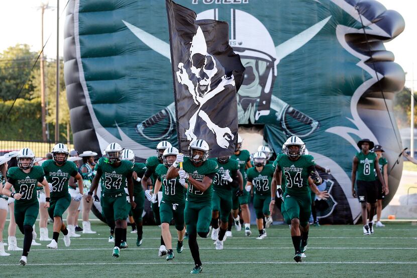 The Poteet Pirates take the field before the start of a high school football game against...