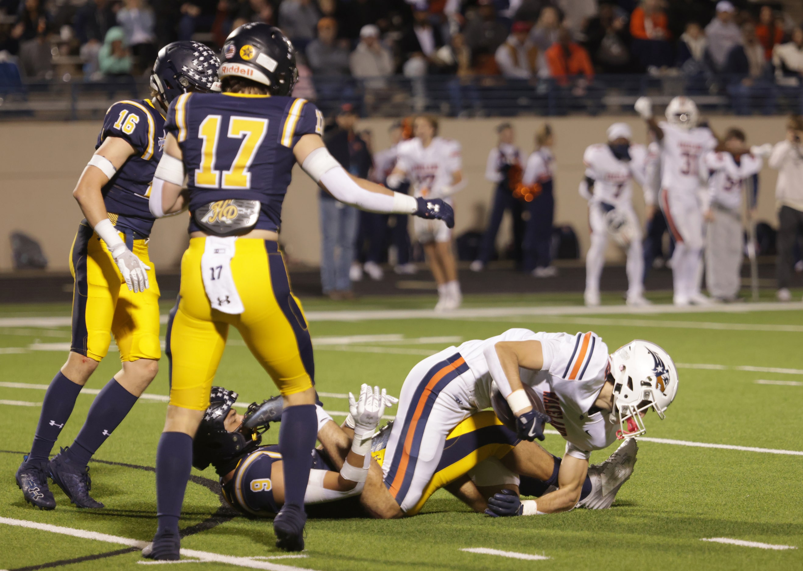 Frisco Wakeland's Ryder Treadway tries to gain control of the ball in a football playoff...