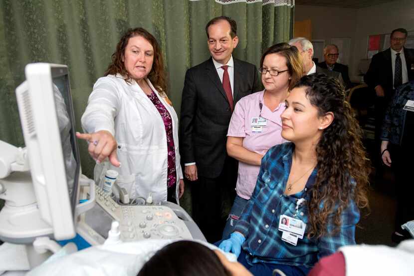 U.S. Labor Secretary Alexander Acosta, center, looks on as echocardiography professor...