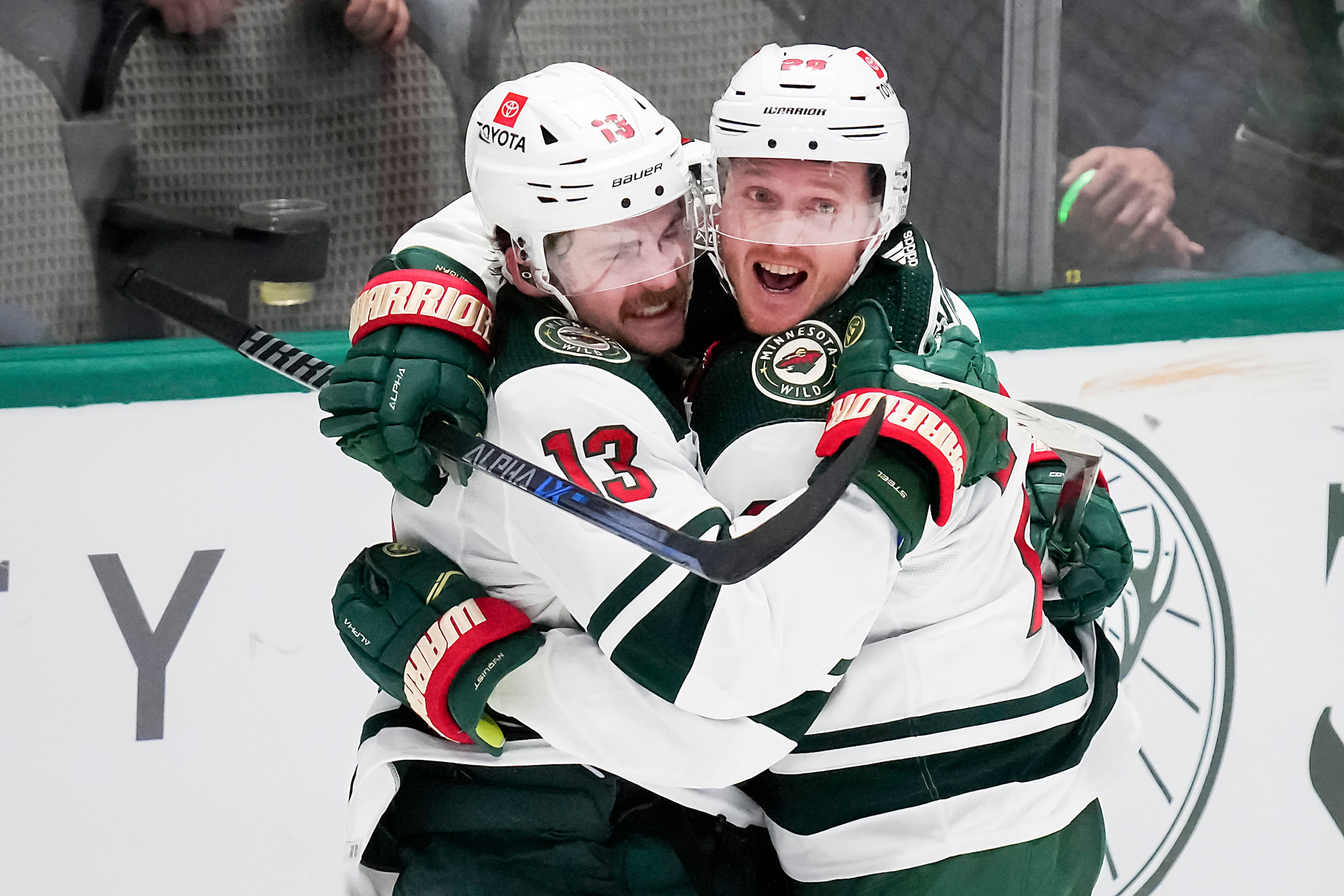 Minnesota Wild center Sam Steel (13) celebrates with center Gustav Nyquist (28) after...