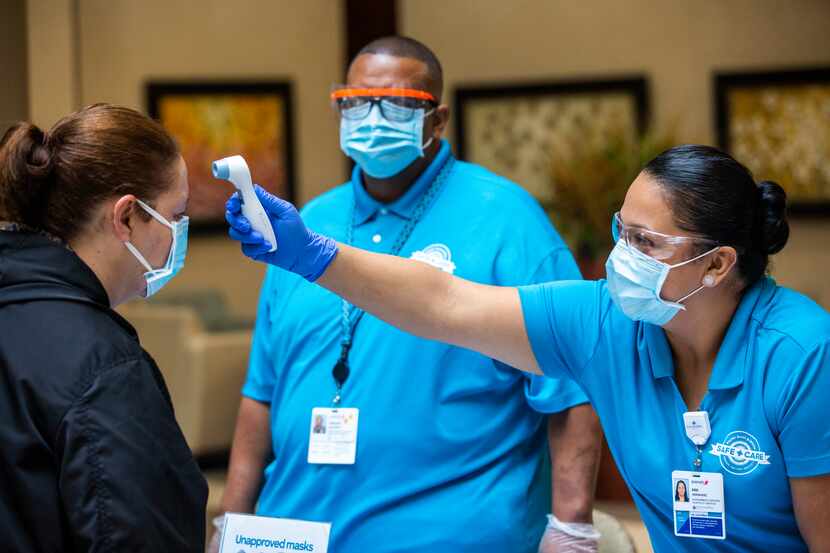 Safe Care screeners Ana Hernandez (right) and Vincent Hargrove (center) record the...