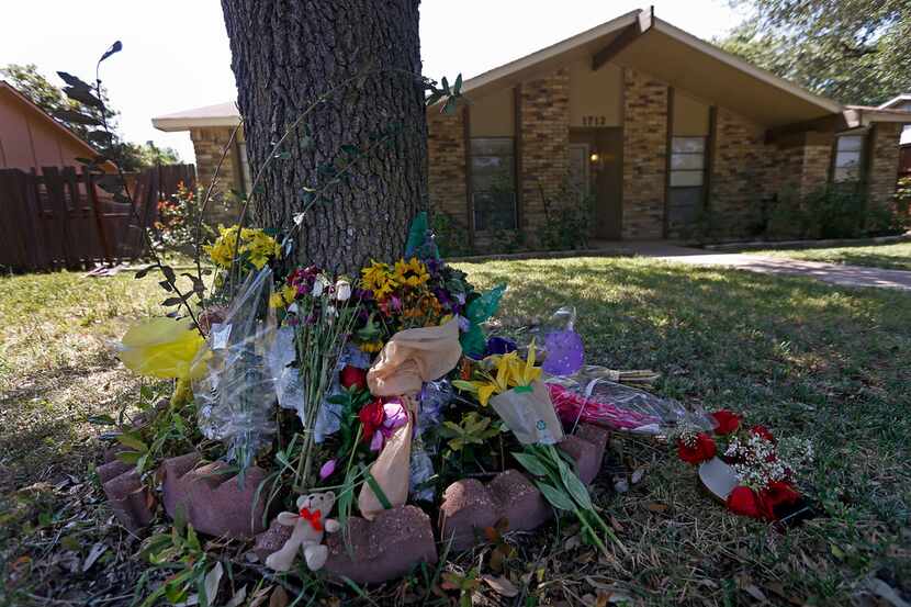 Flowers and other items are placed at a makeshift memorial for the Plano shooting victims...